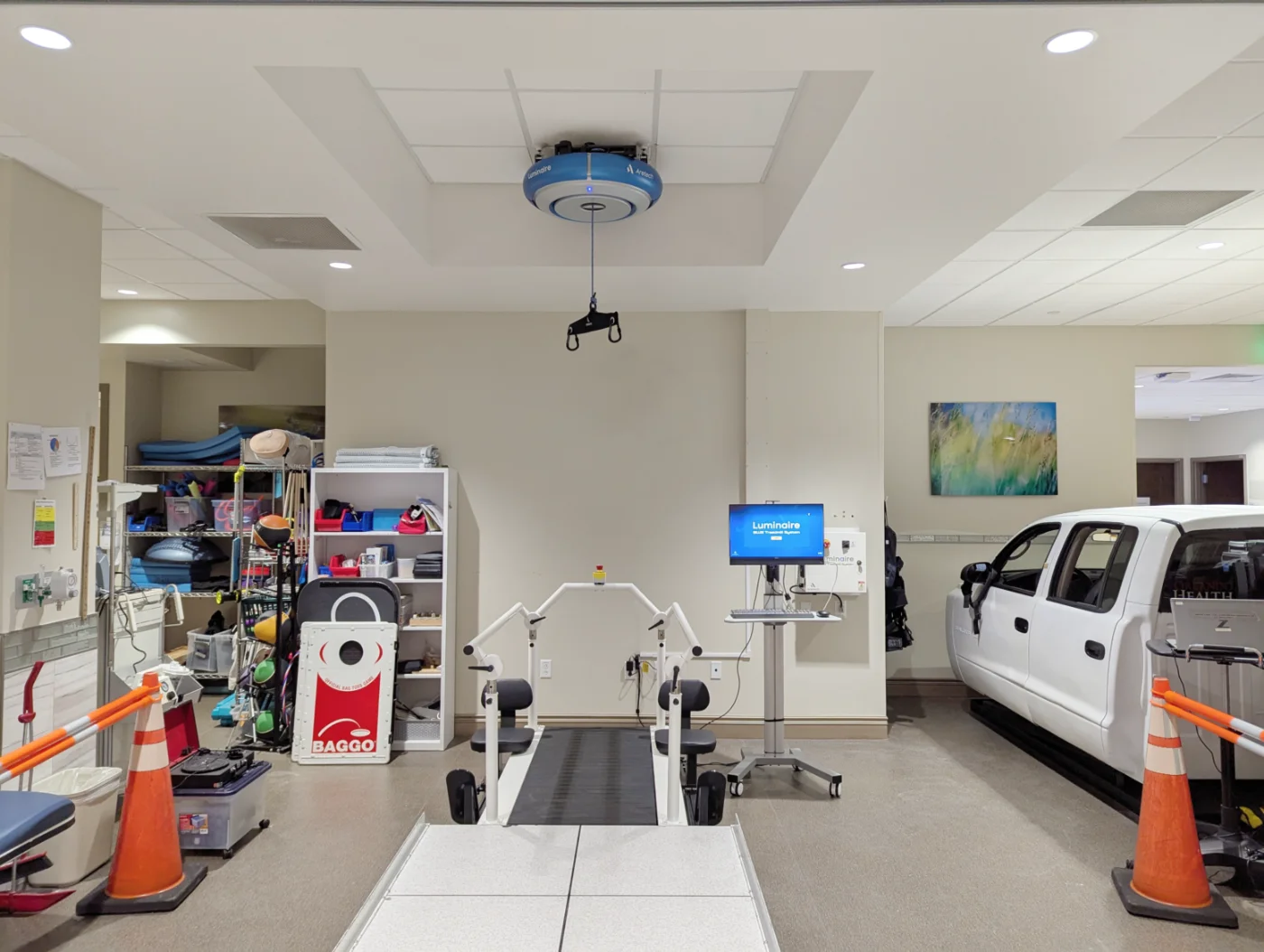 Luminaire overhead unit with DualArrest fall protection above a treadmill in a therapy gym