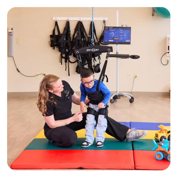 Clinician helping a child to standing