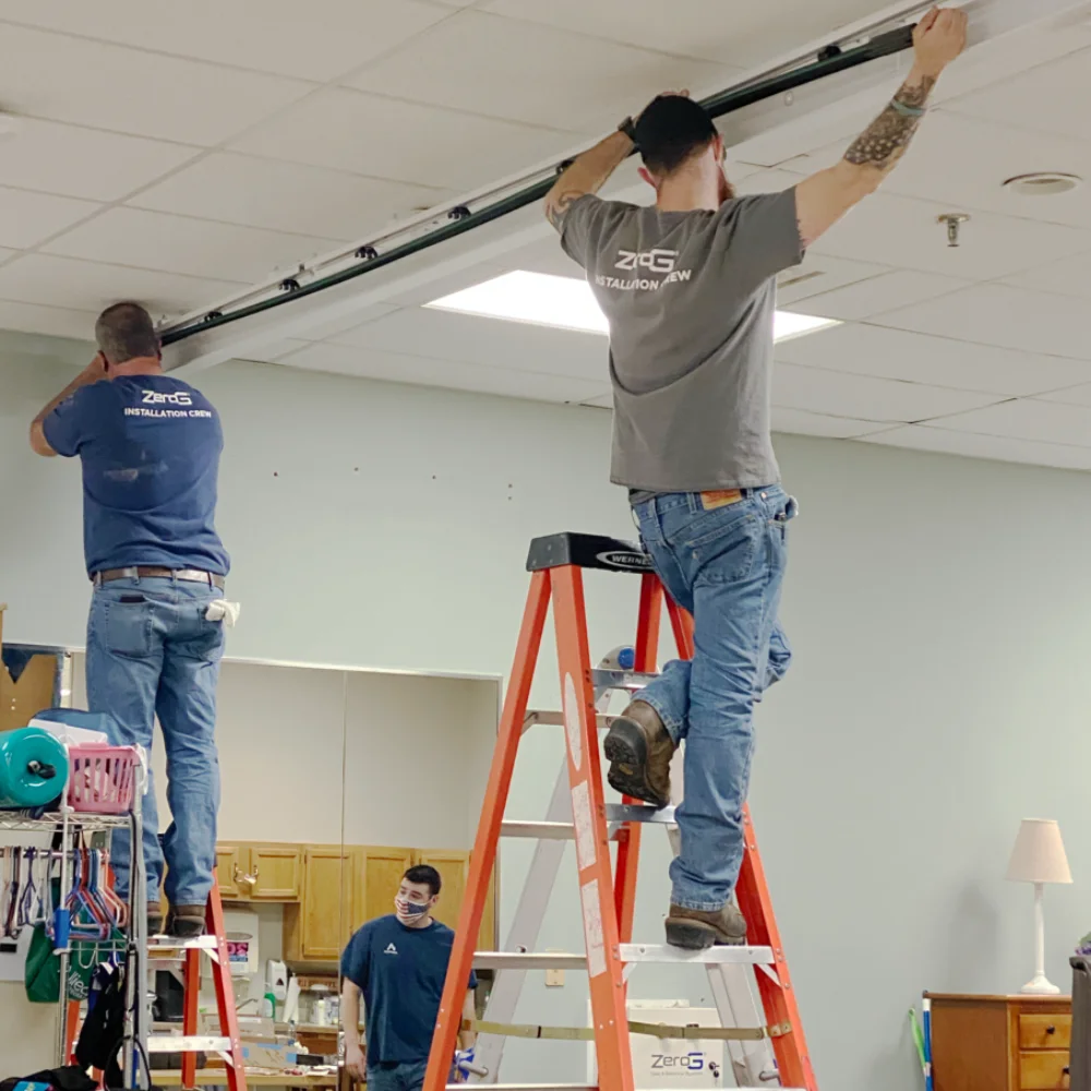 ZeroG installation crew mounting the overhead track