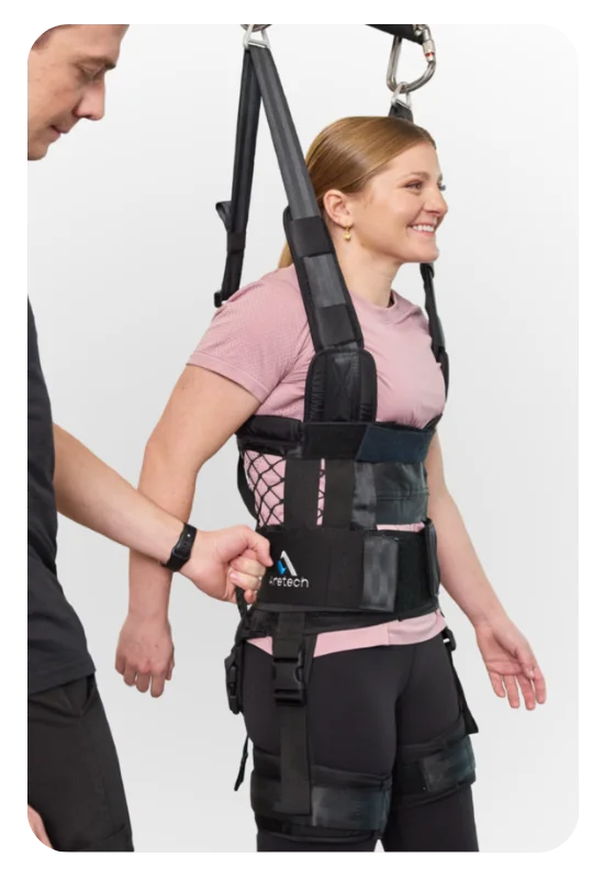 Clinician guiding a patient supported in a ZeroG harness